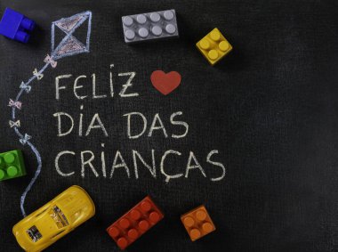 Blackboard Feliz dia das criancas (Portekizce) yazılı. Uçurtma Çizim ve parçaları ve sarı araba montaj. Kopyalama alanı.
