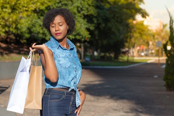 Woman holding shopping during city tour.