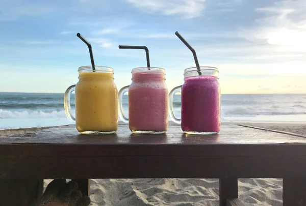 Three Glasses Smoothies Wooden Table Rays Sunset Sea — Stock Photo, Image