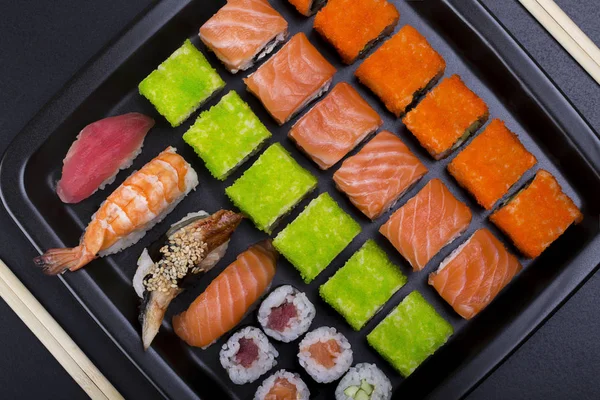 Japoński Sushi Rolki Kształcie Linii Czarnej Płycie Tło Widok Góry — Zdjęcie stockowe