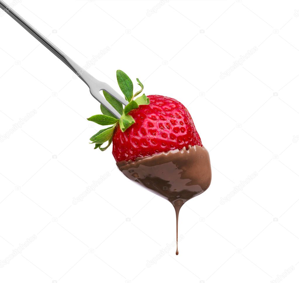 Fondue strawberry soaked in hot black chocolate on a fork isolated on white background