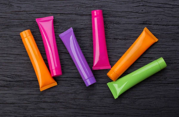 Four bright multi-colored 3D moсkup tubes — Stock Photo, Image