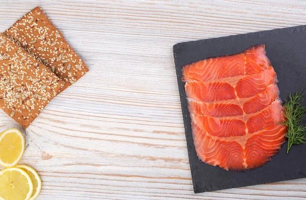 Salted salmon sliced on a slate board close-up