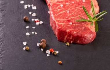 Ahşap arka planda iki taze mermer biftek.