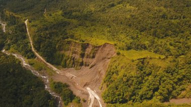 Landslide on the road in the mountains.Camiguin island Philippines. clipart
