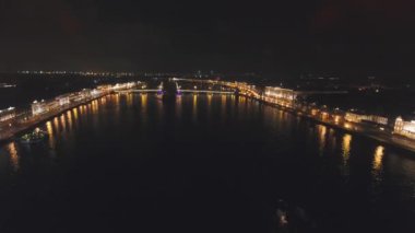 Aydınlatma ile havadan görüntü köprüsü. Nehir üzerinde aydınlatılmış asma köprüyle şehir gecesi sahnesi. Saint Petersburg, Rusya.