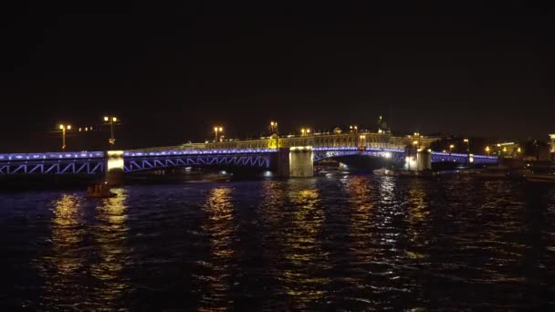Geceleyin nehir üzerinde aydınlık bir köprü — Stok video
