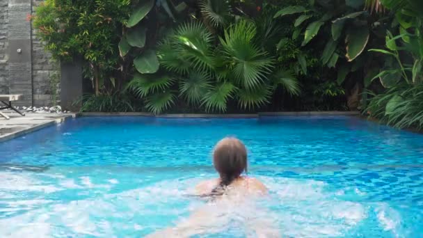 Chica está nadando en la piscina. — Vídeo de stock