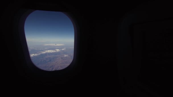 Blick aus dem Flugzeugfenster auf die Berge. — Stockvideo