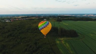 Sıcak hava balonu bir alanın üzerinde gökyüzünde.