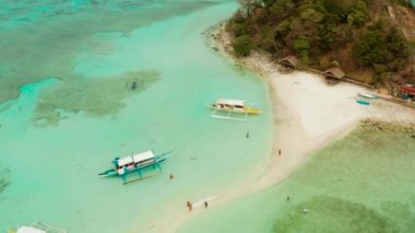 Beyaz kumlu sahili olan küçük torpik bir ada..