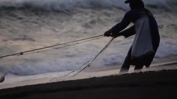 Pêcheur tire filet hors de l'océan — Video