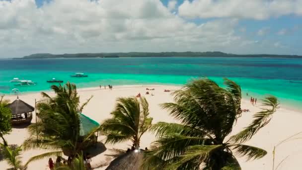 Île tropicale de Daco avec une plage de sable et des touristes.