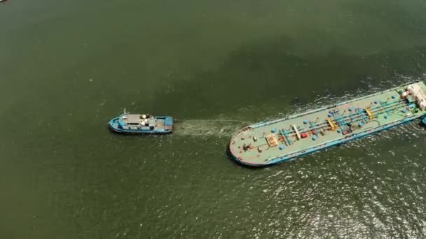 Tugboat pulling heavy loaded barge. — Stock Video