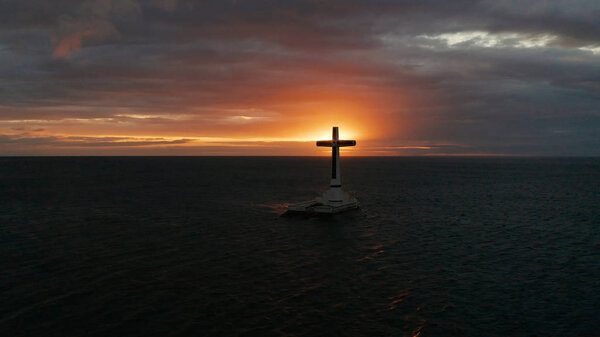 Sunken Cemetery cross in Camiguin island, Philippines.