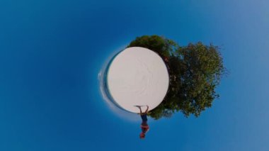 Küçük gezegen manzarası Tropik bir sahil boyunca koşan bir adam.