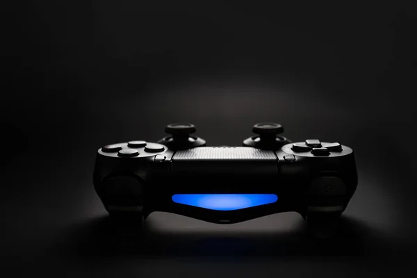 Closeup photo of video game console gamepad joystick controller on black background with blue light. — Stock Photo, Image