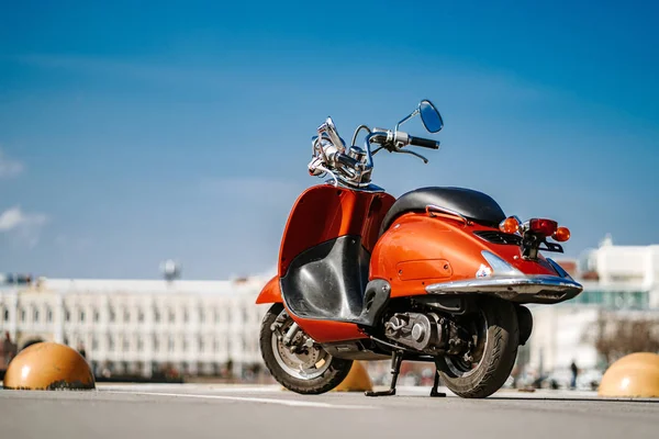 Vista trasera de la moto vintage retro naranja de pie en la calle bajo el cielo azul en la ciudad europea . — Foto de Stock
