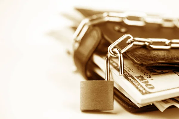 Business safety or financial protection or allow access. Heap of money in chain with open padlock isolated on white