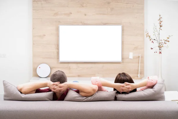 Arkadan görünüş çift erkek ve kadın evinde istirahat, birlikte kanepede oturan ve Tv izlerken