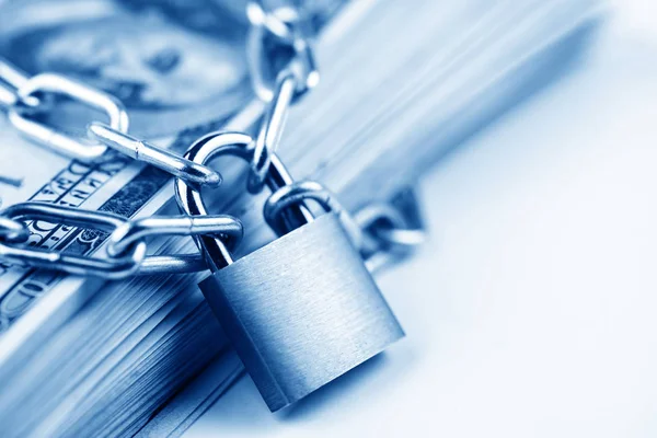 Business safety or financial protection or restriction access. Heap of money in chain with padlock isolated on white