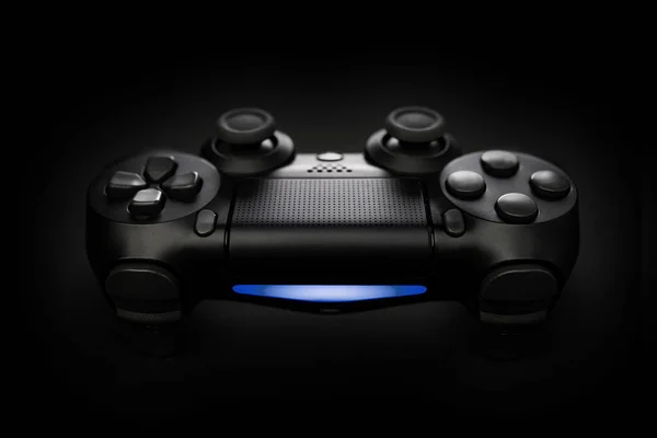 Closeup photo of video game console gamepad joystick controller on black background with blue light. — Stock Photo, Image
