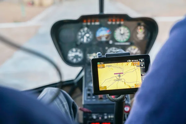 GPS map screen inside helicopter with control panel out of focus in background