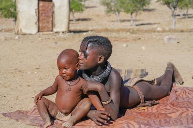 Damaraland Namibya - 21 Mayıs 2018; Sun'ın bebek kardeş içinde yatan Himba kabile Köyü ve insanlar genç kız