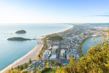 Güneş ufukta doğar ve okyanus plaj ve binalar aşağıdaki düşüyor gibi mount Maunganui güneye aşağıda uzanır