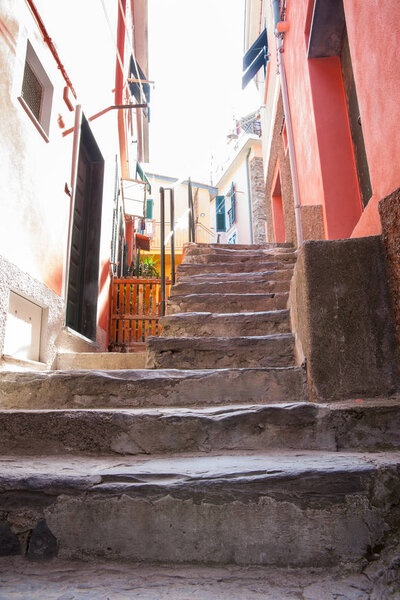 Old steps leading up between two buildings in typically small Italian town