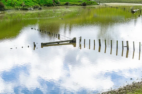Flooded Farm Land Fence Disappearing Water Sky Reflection Surrounded Water — Stock Photo, Image