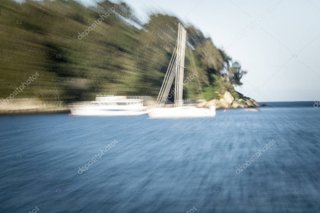 Background image abstract zoom blur at beach with morred yacht and boat