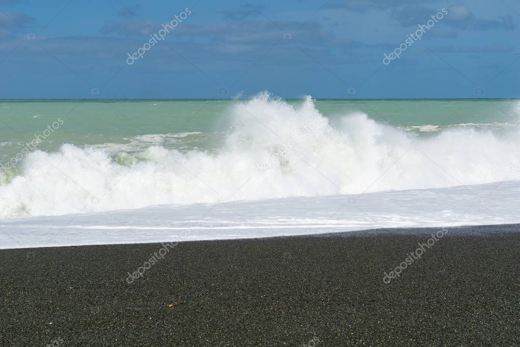 Large dangerous breaking waves on shingle foreshore at Birdlings Flat on Banks Peninsula New Zealand