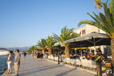 Bir taraftaki kafeler ve restoranlar arasında gezinen çift...