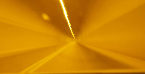 Abstract golden glow in tunnel.