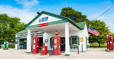 Dwight USA - August 31 2015;  Texaco garage restored with old red Sky Chief fuel pumps and Route 66 Highway signs. clipart