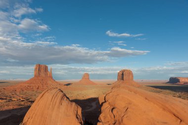 Utah ABD 'de ufka yayılmış jeolojik kaya çıkıntılarının heybetli yapılarından oluşan Anıt Vadisi manzarası