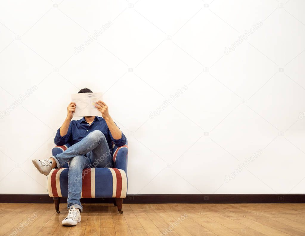 Man reading and sitting on sofa