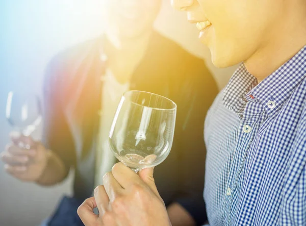 Vintage color effect on men holding glass of wine in the party, close up