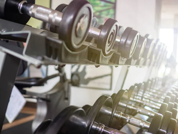 Dumbbells on the rack with light effects