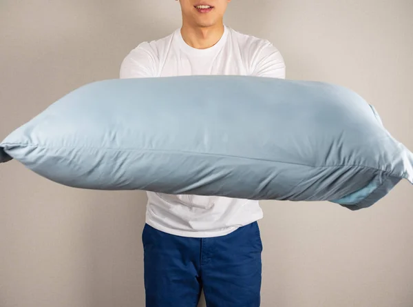 Man lifting a pillow to the front
