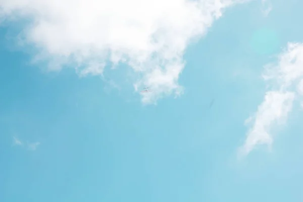 Güneş ve kümülüs beyaz bulutlar güzel mavi gökyüzü, sinek uçak karşı