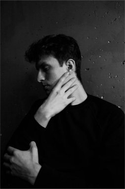 Siyah ve beyaz duygusal bir adam portresi. Dramatik fotoğraf. Işık penceresinden. Düşük anahtar.