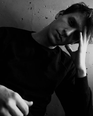 Siyah ve beyaz duygusal bir adam portresi. Dramatik fotoğraf. Işık penceresinden. Düşük anahtar.