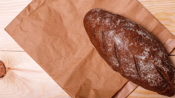 Rye bread on paper bag. Top view. Text place