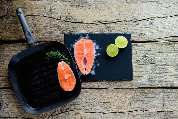 Two Salmon Steaks Ready Cook Grill Lime Wooden Background Top — Stock Photo, Image