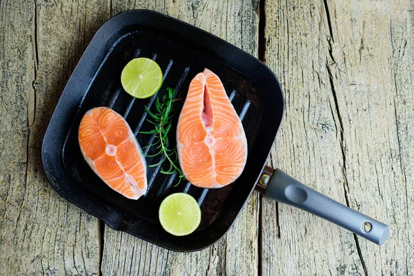 Two Salmon Steaks Ready Cook Grill Lime Wooden Background Top — Stock Photo, Image