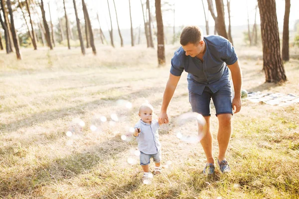 Young father walks with his cute little boy in a forest. Father's Day — Stock Photo, Image