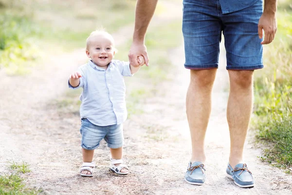 Young father walks with his cute little boy in a forest. Father's Day — Stock Photo, Image