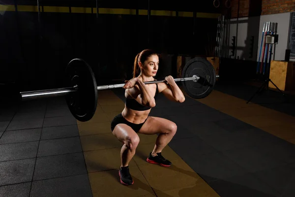 Woman with barbell Caucasian female performing deadlift exercise with barbell